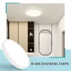 A modern bathroom interior with a ceiling light, cabinets, and a mirror. Anteprima dell’immagine prodotto