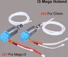 Two 3D printer hotend assemblies with PTFE tubing and wires are displayed against a plain gray background. Text overlays indicate voltage and compatibility. Náhľad obrázku produktu