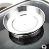 A close-up shot of a silver pot lid with a small hole in the center, resting on a dark, speckled surface. Náhled obrázku produktu