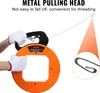 A person wearing white gloves is holding an orange cable puller with a wire extending from it. Produktbild-Vorschau