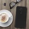 A black Huawei Mate 20 Lite phone case is placed on a wooden table next to a cup of coffee and a pair of glasses. Anteprima dell’immagine prodotto