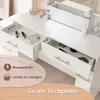 Close-up view of drawers of a white vanity table, showing makeup and accessories inside. Produktbild-Vorschau