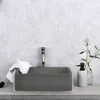 A modern bathroom sink setup with a dark gray basin, a chrome faucet, a white towel, and a soap dispenser. Náhled obrázku produktu