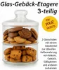 A two-tiered glass cake stand filled with cookies, with descriptive text and a yellow circular graphic. Produktbild-Vorschau