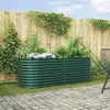 A green metal raised garden bed filled with plants, situated on a paved patio next to a wooden fence. Produktbild-Vorschau