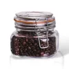 A glass jar filled with coffee beans, with a metal clasp and orange seal. Náhled obrázku produktu