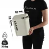A person is holding a white trash can with dimensions and capacity indicated by text and graphics. Produktbild-Vorschau
