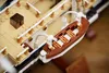 A close-up view of a Lego model ship, focusing on a lifeboat attached to the side. Voir les images du produit