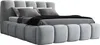 A light gray upholstered bed with a tufted headboard and footboard, shown from a side angle. Produktbild-Vorschau