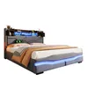 A modern upholstered bed with a headboard featuring shelves and LED lighting, presented against a white background. Podgląd zdjęcia produktu