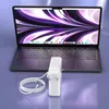 A white laptop charger and cable are placed in front of an open laptop. Produktbild-Vorschau