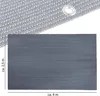 A close-up view of a rectangular fabric mat with grommets along the edges, and a textured pattern. A smaller section above shows a close-up of the fabric weave and a grommet. Produktbild-Vorschau