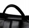 A close-up shot of the top handle and straps of a black bag. Náhľad obrázku produktu