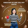 A woman holding a red mug of coffee, surrounded by coffee beans and marketing text. Podgląd zdjęcia produktu