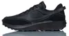 A black Nike Waffle Debut sneaker is shown from the side against a white background. Náhled obrázku produktu
