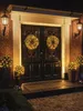 A decorated doorway with Christmas lights and wreaths. Produktbild-Vorschau