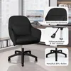 A black office chair is shown in a home office setting with a desk and computer. Voir les images du produit