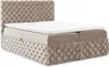 A tufted beige boxspring bed with a white mattress topper, shown from a side-angle on a white background. Produktbild-Vorschau