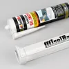 Two sealant tubes are shown on a light gray background. One tube is in focus in the foreground, and the other is slightly out of focus in the background. Produktbild-Vorschau