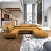 A spacious, modern living room with a large sectional sofa, dining area, and kitchen in the background. Produktbild-Vorschau