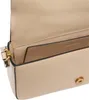 Close-up view of the interior of a beige handbag, showing the lining and a small pocket. Podgląd zdjęcia produktu