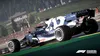 A Formula 1 racing car on a track with spectators in the background. Produktbild-Vorschau