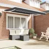 An awning fabric is shown installed above a window on a brick house, with outdoor furniture on a wooden deck below. Anteprima dell’immagine prodotto