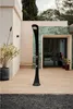 An outdoor shower on a wooden deck next to a building. Produktbild-Vorschau