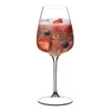 A single wine glass filled with a pink beverage, ice, and berries. Produktbild-Vorschau