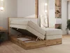 A bedroom scene featuring a boxspring bed with storage, showcasing its open compartment. Produktbild-Vorschau