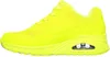 A side view of a single yellow sneaker against a white background. Voir les images du produit