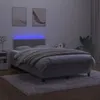 A bed with a headboard and mattress, illuminated by blue LED lights. Produktbild-Vorschau