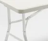 A close-up view of the white metal legs and frame of a folding table. Produktbild-Vorschau
