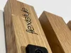Close-up of a wooden coat hook with the brand name 'flexistyle' engraved on it. Náhled obrázku produktu