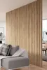 A living room with a wooden slat room divider and a sofa. Anteprima dell’immagine prodotto