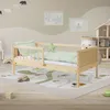 A child's bedroom with a wooden toddler bed, rug, and wall decorations. Produktbild-Vorschau
