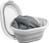A collapsible laundry basket filled with folded towels. Produktbild-Vorschau