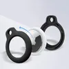 An Apple AirTag with two protective silicone rings, one black and one black, shown in a disassembled view. Produktbild-Vorschau