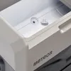 A close-up view of the interior of a white cooler box, showing a drain plug and a cap. Náhľad obrázku produktu