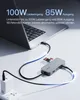 A laptop connected to a USB-C hub, which is also connected to a power adapter and has SD cards inserted. Produktbild-Vorschau