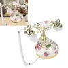 A vintage-style telephone with floral patterns is shown against a neutral background. Náhľad obrázku produktu