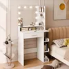 A white vanity table with a mirror and LED lights is set up next to a bed in a bedroom. Produktbild-Vorschau
