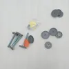 Various parts of a Hauck door gate are laid out on a light gray surface. Voir les images du produit