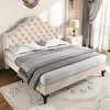 A beige upholstered bed with a tufted headboard is shown in a bedroom setting. Produktbild-Vorschau