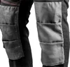 A close-up view of the knee area of black work pants, showing reinforced gray knee patches with stitching. Anteprima dell’immagine prodotto