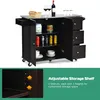 A black kitchen cart with a stainless steel top, open doors revealing shelves with cans and bowls, and drawers on the side. A wine bottle and glasses are on the countertop. A separate inset shows a diagram of adjustable shelf heights. Podgląd zdjęcia produktu