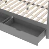 A close-up view of the underside of a bed frame, showing wooden slats and two gray drawers. Podgląd zdjęcia produktu
