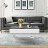 A modern living room scene featuring a gray sofa and a white and gray coffee table. Podgląd zdjęcia produktu