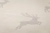 A close-up view of a textured fabric with a repeating pattern of deer silhouettes. Produktbild-Vorschau