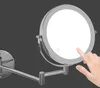 A close-up of a wall-mounted LED cosmetic mirror with a hand touching the illuminated surface. Produktbild-Vorschau